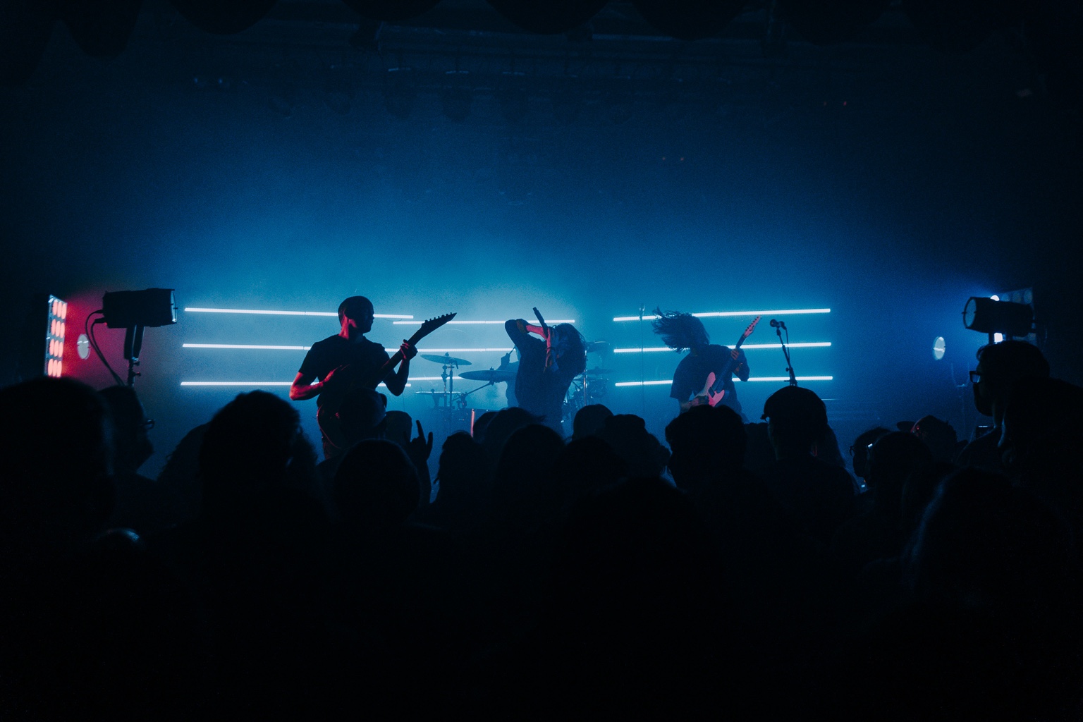 Vespera performing under blue stage lights